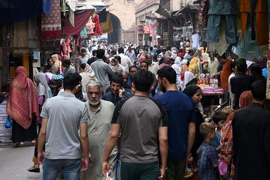 In this picture taken on 16 April 2023, people throng a market area in Lahore, Pakistan. (Arif Ali/AFP)