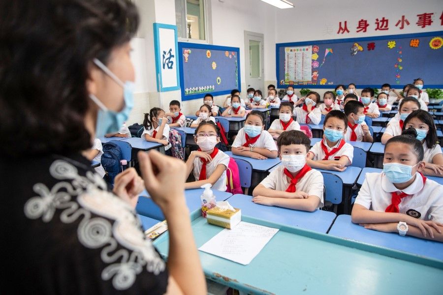 This photo taken on 1 September 2020 shows elementary school students attending a class on the first day of the new semester in Wuhan in China's central Hubei province. (STR/AFP)