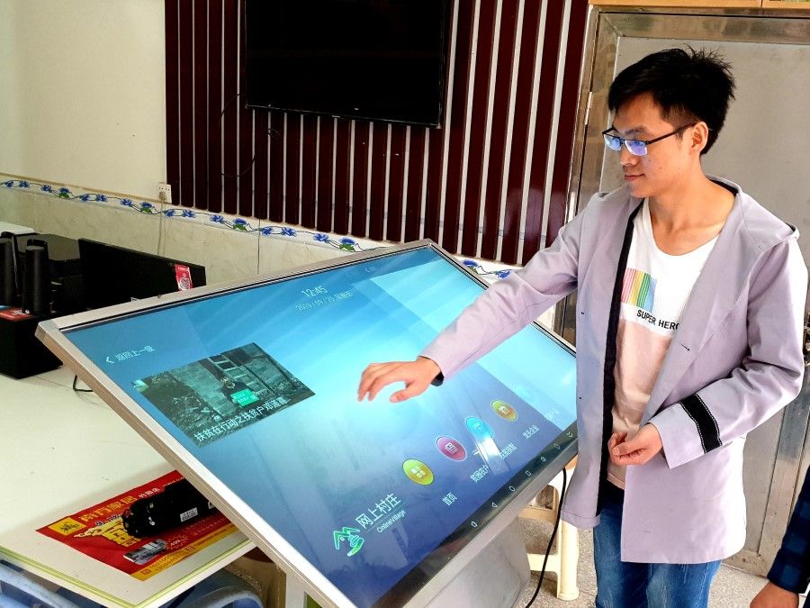 Young e-commerce entrepreneur Wen Xin talks to this reporter while checking orders on a big screen.
