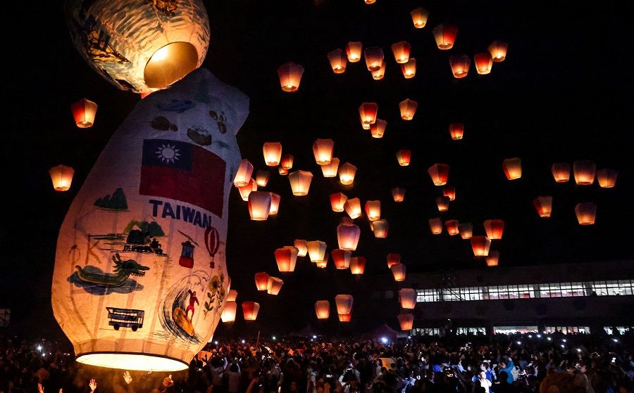 A Taiwan-shaped lantern is released among others by tourists during the Pingxi Lantern Festival in New Taipei City on 17 February 2024. (I-Hwa Cheng/AFP)