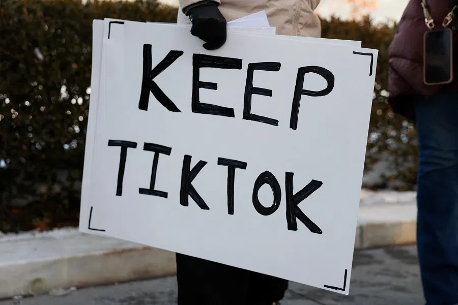 A TikTok influencer holds a sign that reads “Keep TikTok” outside the US Supreme Court Building as the court hears oral arguments on whether to overturn or delay a law that could lead to a ban of TikTok in the US on 10 January 2025 in Washington, DC.