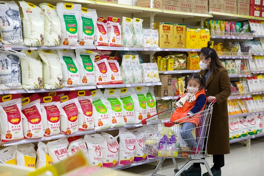 In this file photo, a consumer is choosing flour at a supermarket in Taiyuan city, Shanxi province, China. Chinese officials have repeatedly reassured the Chinese people that food supplies are sufficient and there is no need to hoard. (CNS)
