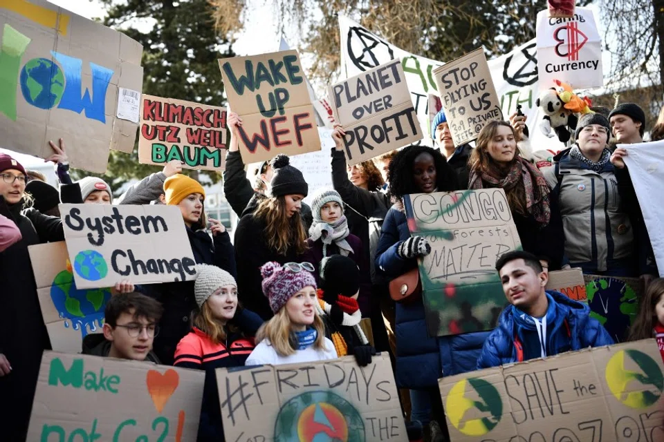 In this file photo taken on 24 January 2020, climate activists including Greta Thunberg (centre) march in a street of Davos on the sideline of the World Economic Forum (WEF) annual meeting. (Fabrice Coffrini/AFP)