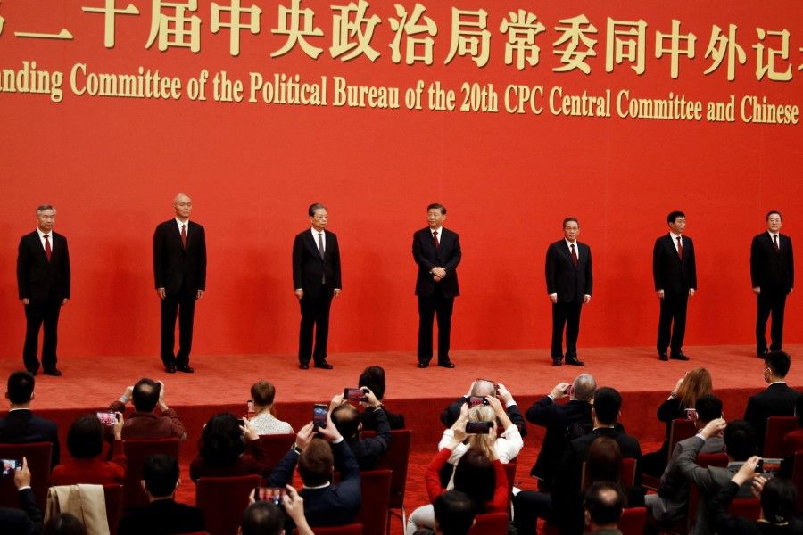 New Politburo Standing Committee members (left to right) Li Xi, Cai Qi, Zhao Leji, Xi Jinping, Li Qiang, Wang Huning and Ding Xuexiang meet the media following the 20th Party Congress of the Communist Party of China, at the Great Hall of the People in Beijing, China, 23 October 2022. (Tingshu Wang/Reuters)