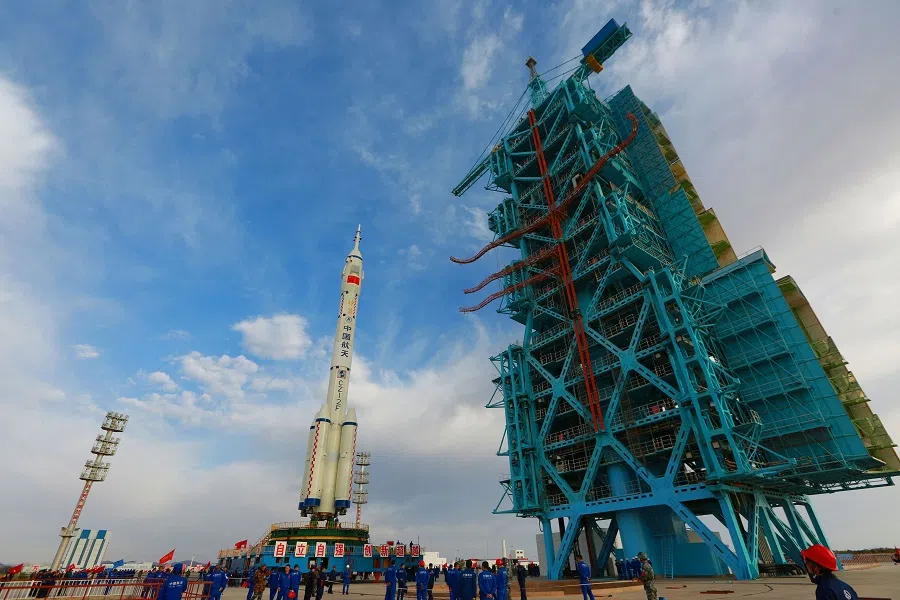 This photo taken on 7 October 2021 shows a Long March-2F carrier rocket, carrying the Shenzhou-13 spacecraft, being transported to the launching area at the Jiuquan Satellite Launch Centre in Gansu province, China. (STR/AFP)