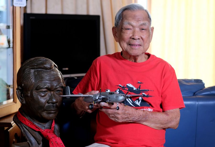 "But at the same time, you have to learn to accept things. When hardships come, you have to assess it. Not everybody can go through it, but you have to learn to accept it. Learn to be kinder. That's all. That's my value in life." Ho holding the B-25 bomber model. He used to fly it during WWII. (Long Kwok Hong/SPH)