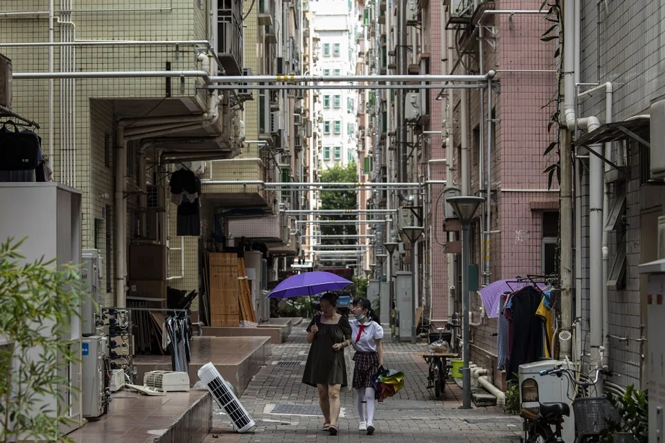 Residents walk through Huanggang village in Shenzhen, China, on 11 October 2021. (Qilai Shen/Bloomberg)