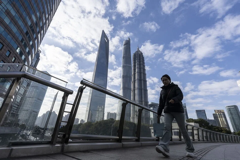 A pedestrian passes buildings in Pudong’s Lujiazui Financial District in Shanghai, China on 2 January 2025. (Qilai Shen/Bloomberg)