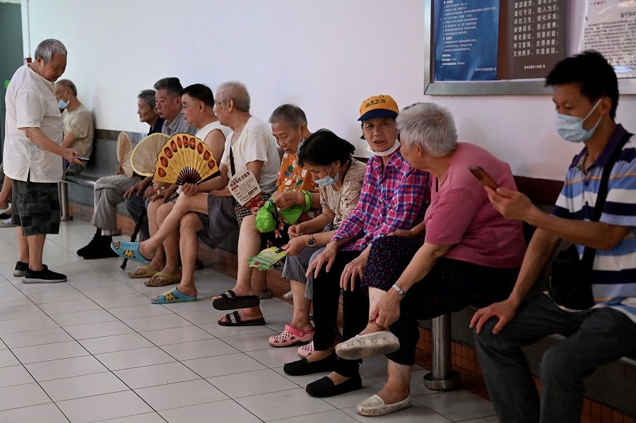 Elderly people rest inside a mall in Chongqing, China, on 24 August 2022. (Noel Celis/AFP)