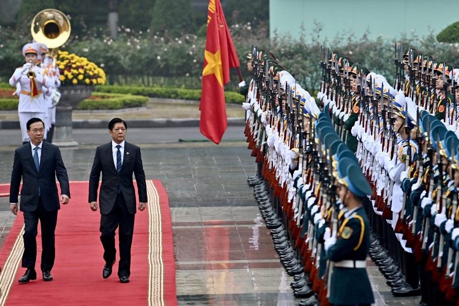 Philippine's Ferdinand Romualdez Marcos Jr (right) and Vietnam's President Vo Van Thuong (left) inspect the guard of honour during a welcoming ceremony at the Presidential Palace in Hanoi on 30 January 2024. (Nhac Nguyen/AFP)