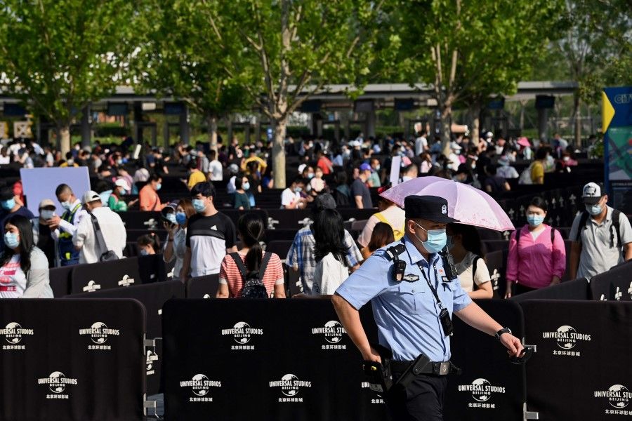 People queue to enter the Universal Studios Beijing theme park during an invitation-only test run in Beijing on 1 September 2021, ahead of its opening on 20 September. (Noel Celis/AFP)