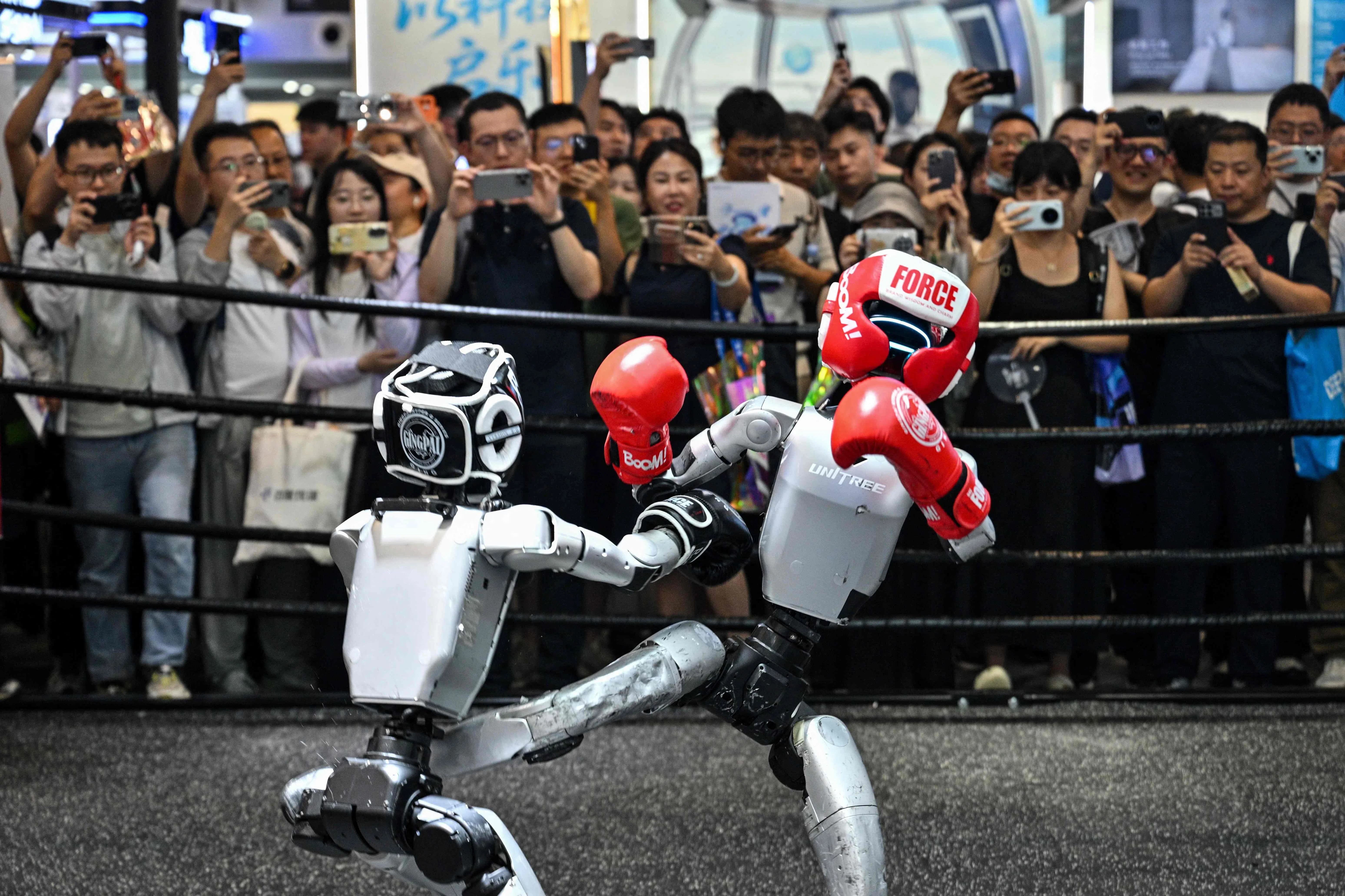 Humanoid robots controlled by a remote control by Unitree Robotics take part in a fight during the World Artificial Intelligence Conference (WAIC) in Shanghai on 18 July 2026.