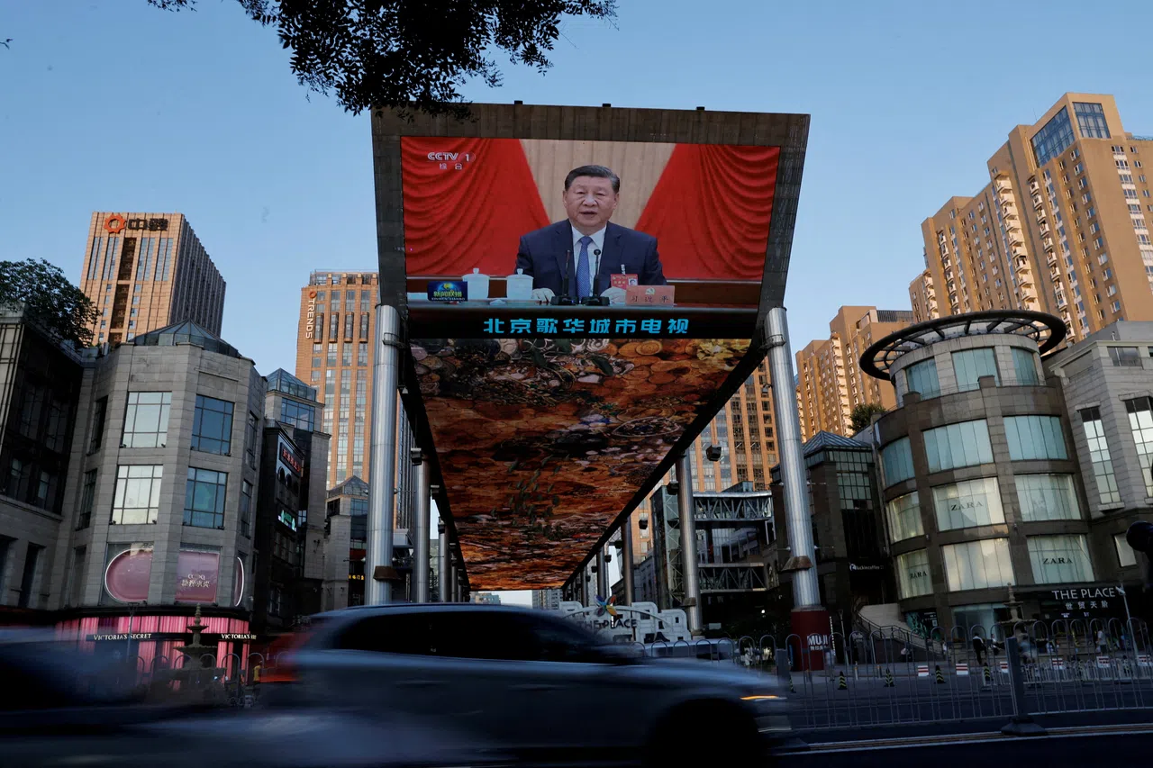 A giant screen shows news footage of Chinese President Xi Jinping attending the third plenary session of the 20th Central Committee of the Chinese Communist Party in Beijing, China on 18 July 2024. 