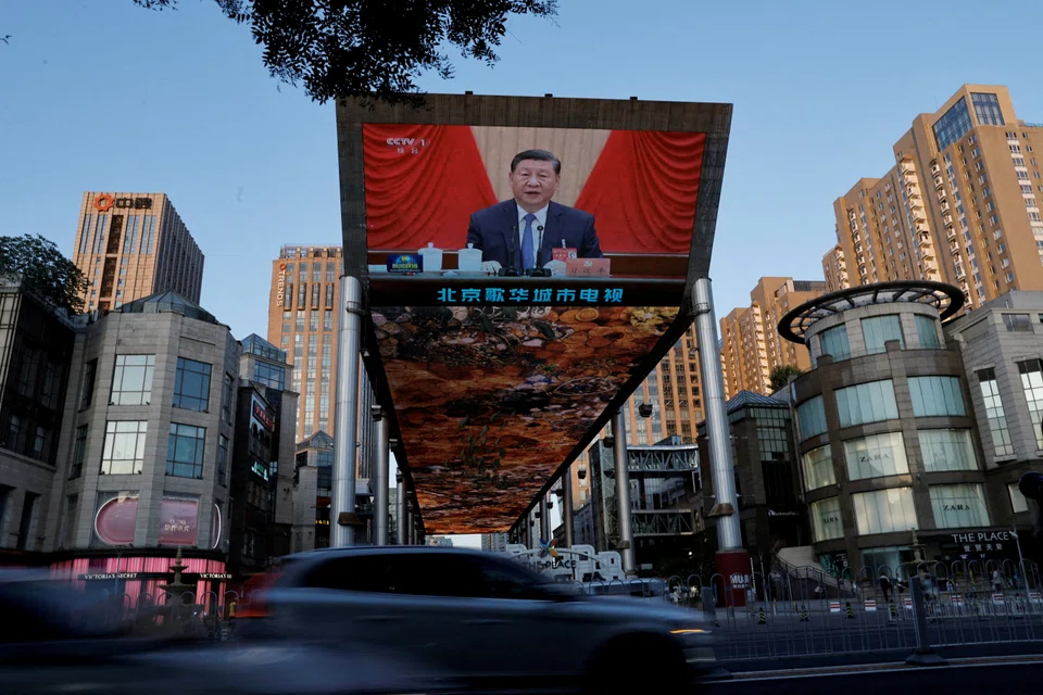 A giant screen shows news footage of Chinese President Xi Jinping attending the third plenary session of the 20th Central Committee of the Chinese Communist Party in Beijing, China on 18 July 2024.  (Tingshu Wang/Reuters)