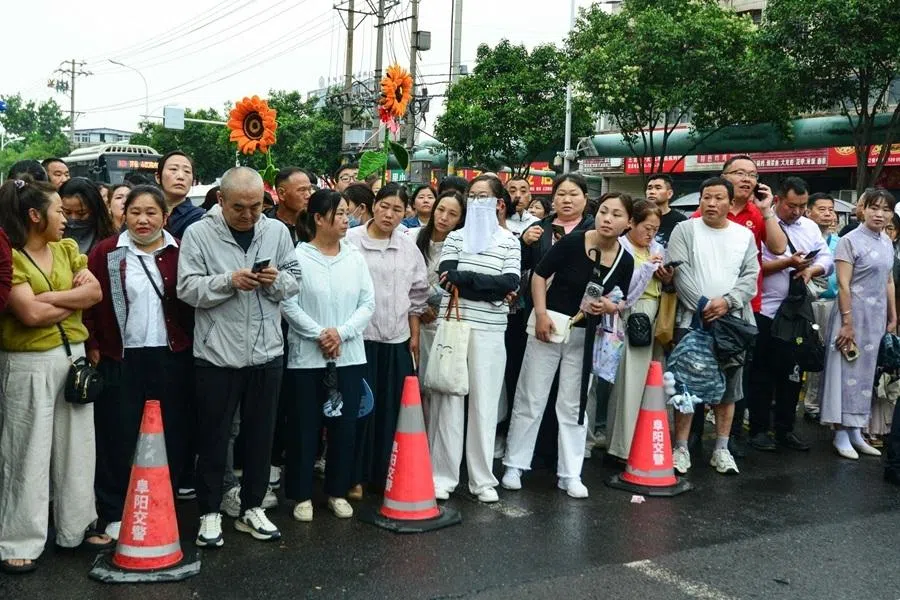 Parents wait outside for their children to come out after sitting for their gaokao in Fuyang, Anhui province, China, on 7 June 2026.