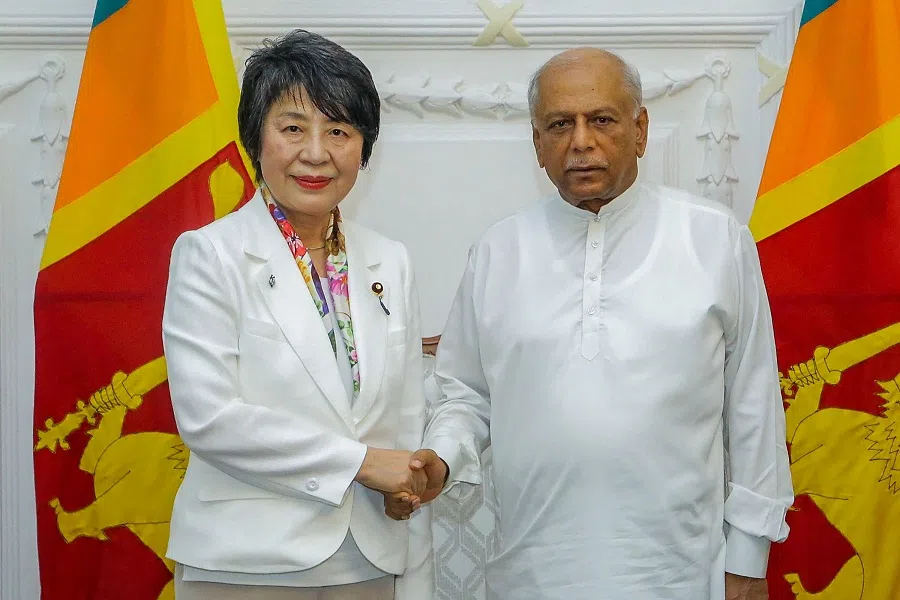 This handout photograph taken and released by the Sri Lankan Prime Minister’s Office on 4 May 2024 shows Japan’s Foreign Minister Yoko Kamikawa shaking hands with Sri Lanka’s Prime Minister Dinesh Gunawardena (right), after a meeting in Colombo. (Sri Lanka Prime Minister’s Office/AFP)