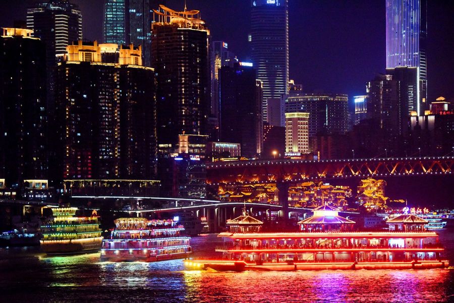 Chongqing's beautiful city skyline by night. A cruise ship is seen passing by Hongyadong. (Xinhua)