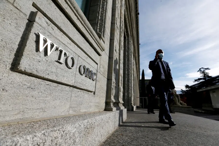A delegate arrives before a meeting at the World Trade Organization (WTO) in Geneva, Switzerland, 28 October 2020. (Denis Balibouse/Reuters)