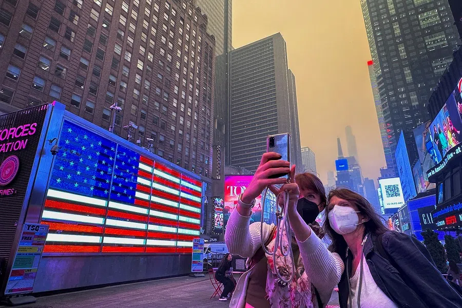 People take photos in Times Square in New York City, US, on 7 June 2023. (Maye-E Wong/Reuters)