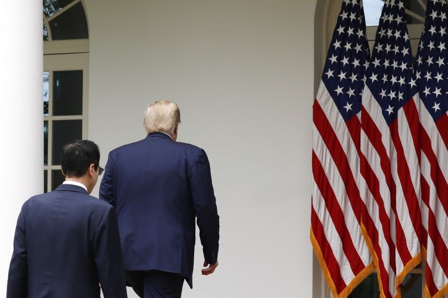 U.S. President Donald Trump and Steven Mnuchin, U.S. Treasury secretary, left, exit after a news conference in the Rose Garden of the White House in Washington, D.C., U.S., on Friday, 29 May, 2020. Trump said the U.S. will terminate its relationship with the World Health Organization, which he has accused of being under Chinese control and failing to provide accurate information about the spread of coronavirus. (Yuri Gripas/Bloomberg)