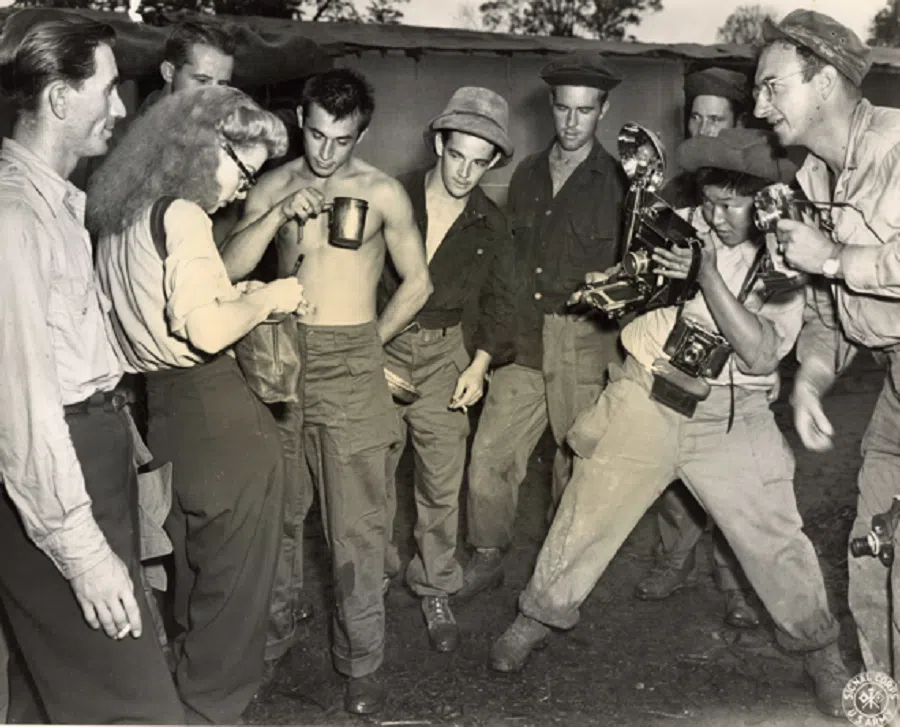 Chinese-American photographer Corporal Tom Amer photographs American actress Ann Sheridan, 31 August 1944.