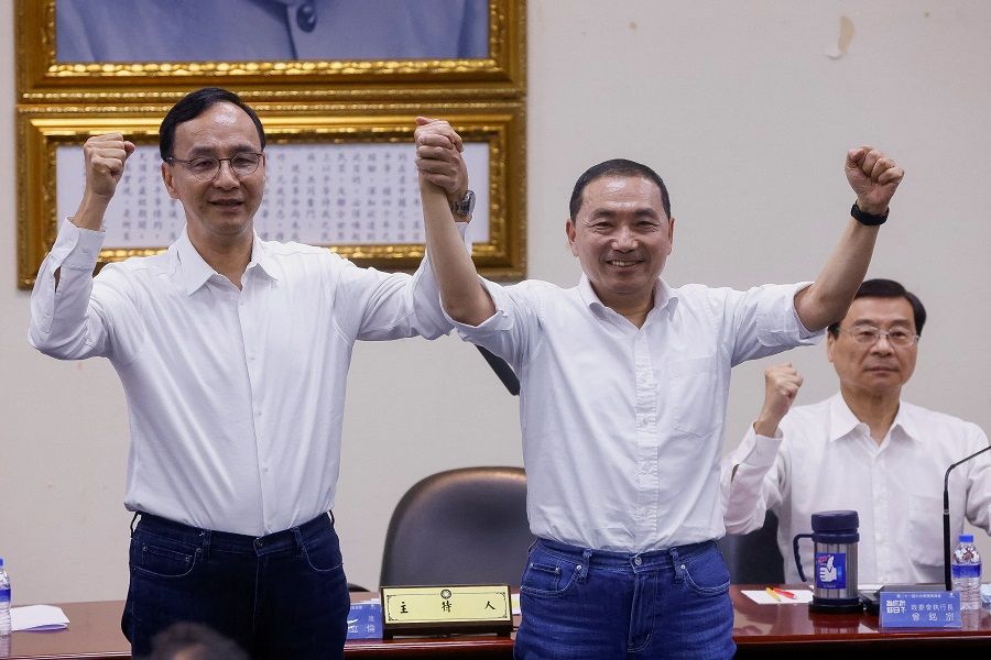 The chair of the Kuomintang (KMT), Taiwan's main opposition party, Eric Chu (left) and mayor of New Taipei Hou You-yi celebrate as Hou becomes the presidential candidate, in Taipei, Taiwan, 17 May 2023. (Ann Wang/Reuters)