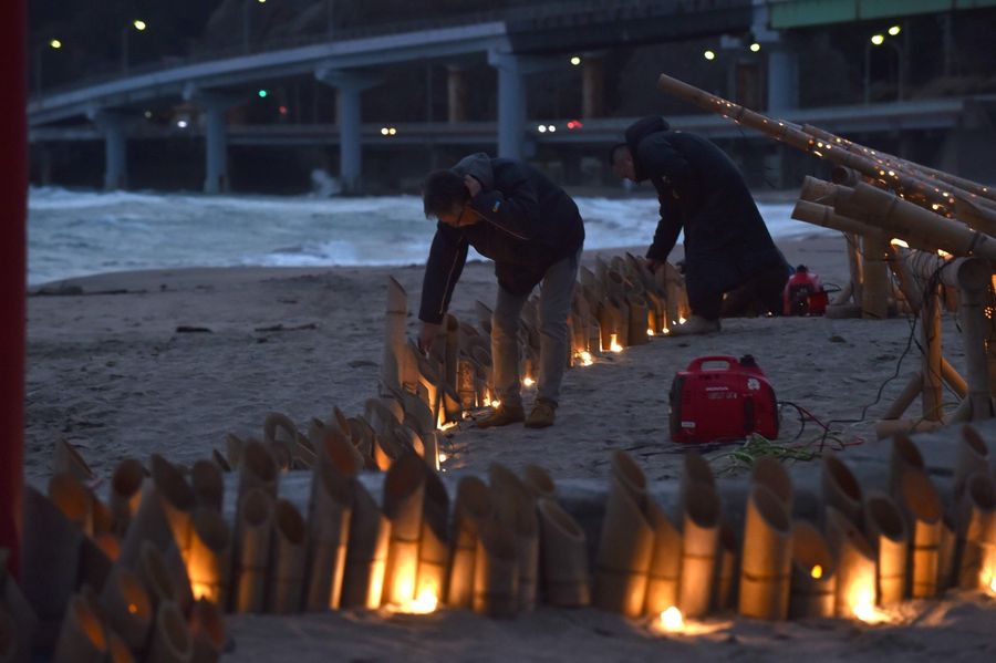 Local volunteers prepare a candle service for people who have just returned from Wuhan and are quarantined in a hotel in Katsuura, Chiba prefecture, on 12 February 2020. (Kazuhiro Nogi/AFP)