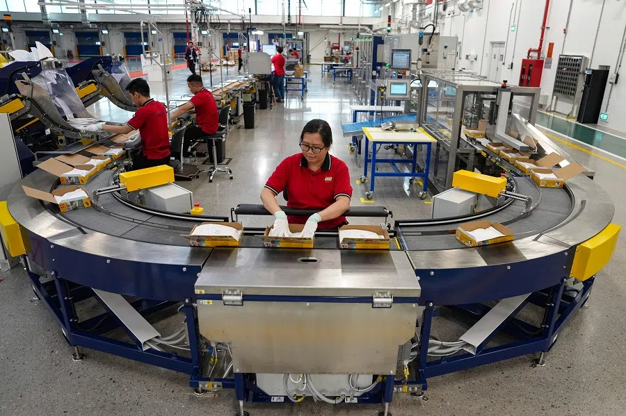 Employees prepare Lego packages on a production-line during the inauguration of the Lego factory in Binh Duong Province on 9 April 2025. 
