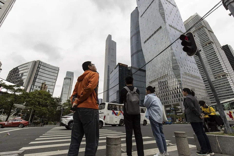 Pedestrians at a crossing in the Zhujiang New Town area in Guangzhou, China, on 16 November 2023. (Qilai Shen/Bloomberg)