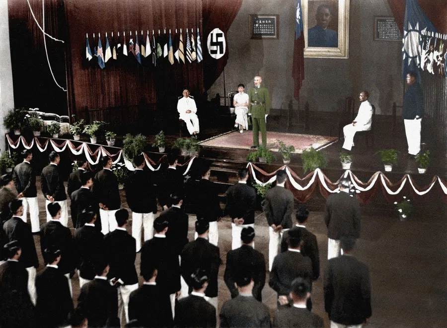 In June 1936, the head of the Kuomintang government Chiang Kai-shek addressed Chinese athletes the day before they left to participate in the Berlin Olympics. Behind Chiang are the Chinese and German flags.