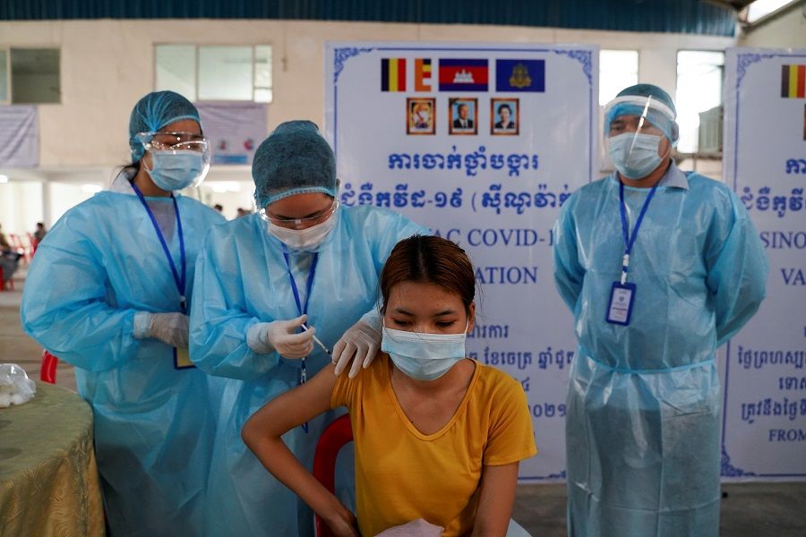 A garment factory worker receives China's Sinovac Covid-19 vaccine at an industrial park in Phnom Penh, Cambodia, 7 April 2021. (Cindy Liu/Reuters)