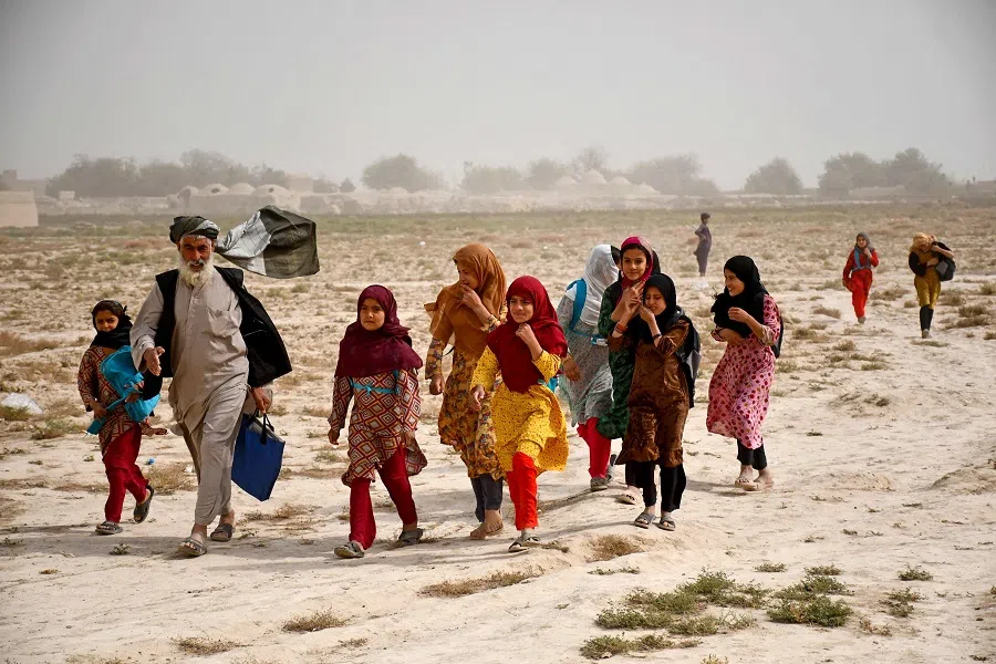 Afghan school girls walk back home, at Chahar Bolak district in Balkh province on 22 October 2024.
