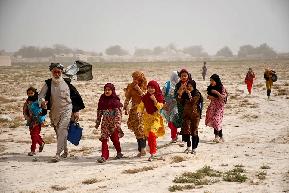 Afghan school girls walk back home, at Chahar Bolak district in Balkh province on 22 October 2024. (Atif Aryan/AFP)