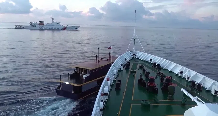 This video frame grab from footage taken and released on 22 October 2023 by the Chinese Coast Guard (CCG) through the Chinese embassy in Manila shows a collision between a Chinese Coast Guard ship (right) and a Philippine resupply boat (left) during a resupply mission in Second Thomas Shoal, in the disputed South China Sea. (Handout/Chinese Coast Guard/AFP)