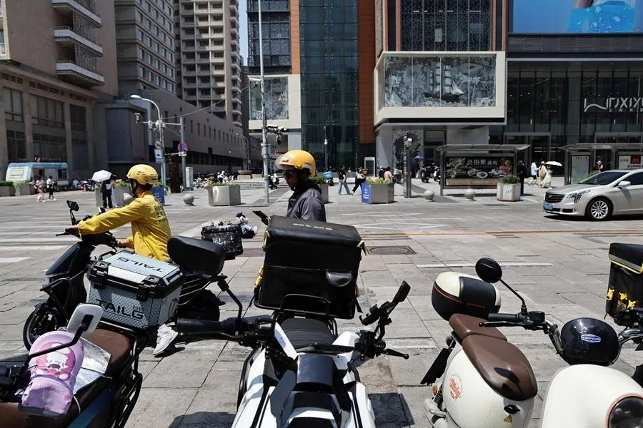 Delivery riders seen along the street in Beijing, China, on 24 June 2025.