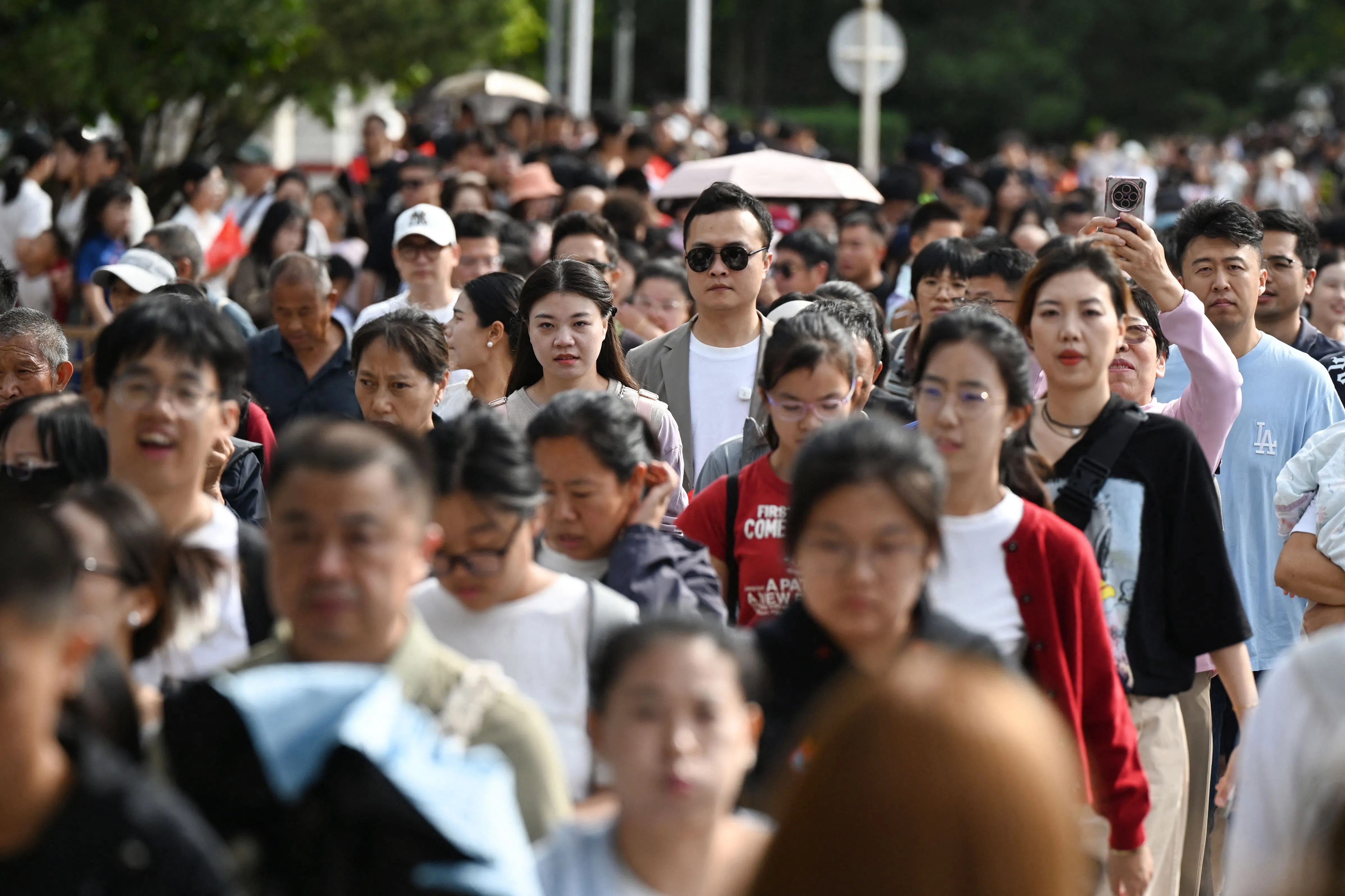 Crowds walk towards Tiananmen Square on China’s National Day in Beijing on 1 October 2025. (Greg Baker/AFP)