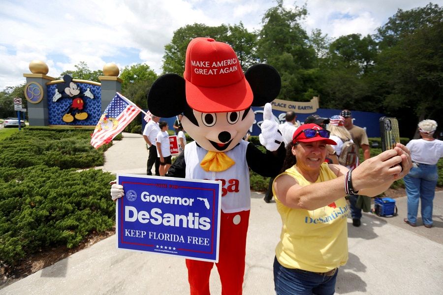 A person wearing a mouse costume takes selfies with supporters of Florida's Republican-backed "Don't Say Gay" bill that bans classroom instruction on sexual orientation and gender identity for many young students gather for a rally outside Walt Disney World in Orlando, Florida, US, 16 April 2022. (Octavio Jones/File Photo/Reuters)