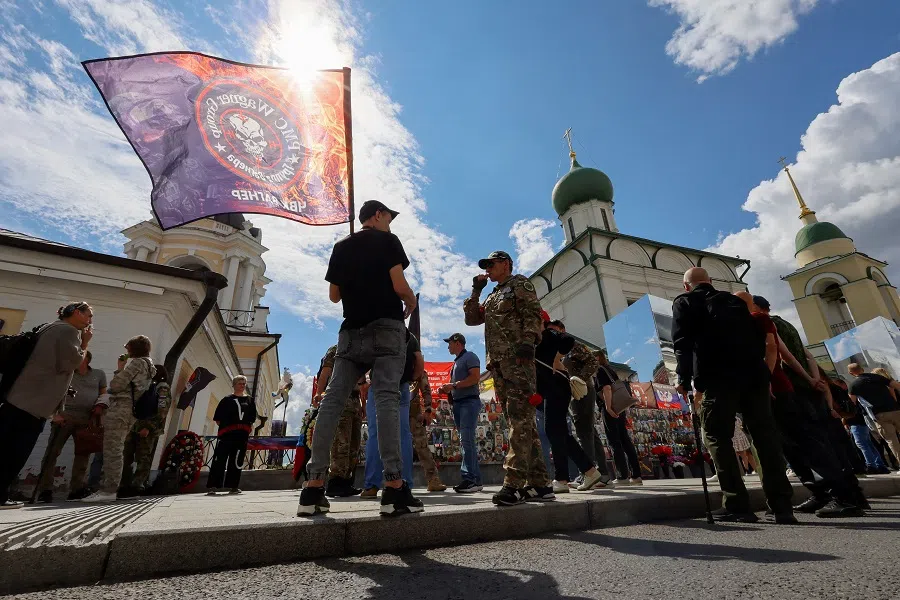 People gather near a makeshift memorial, which was erected following head of Russia’s Wagner mercenary group Yevgeny Prigozhin and group commander Dmitry Utkin’s death in 2023, during a commemoration ceremony held to pay tribute to Wagner fighters, who were recently killed in Mali by northern Tuareg rebels, in central Moscow, Russia, on 4 August 2024. (Yulia Morozova/Reuters)