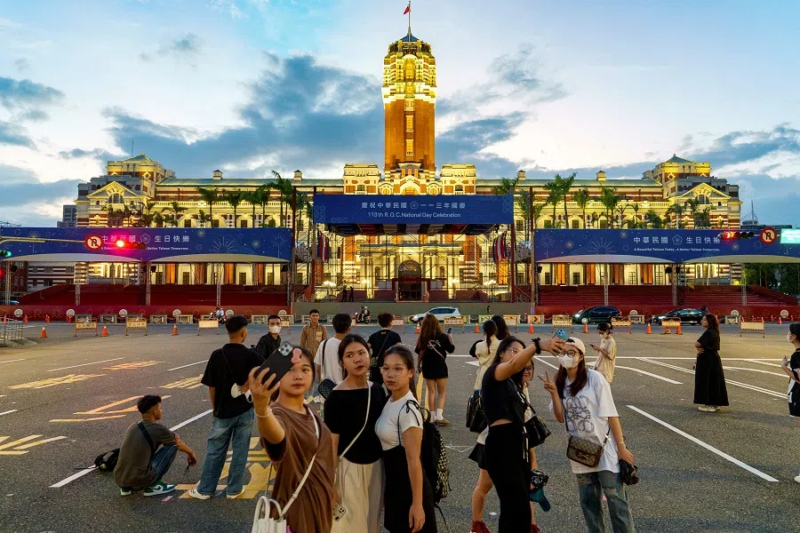 People take pictures near the partially decorated presidential office in Taipei on 28 September 2024. (Yan Zhao/AFP)