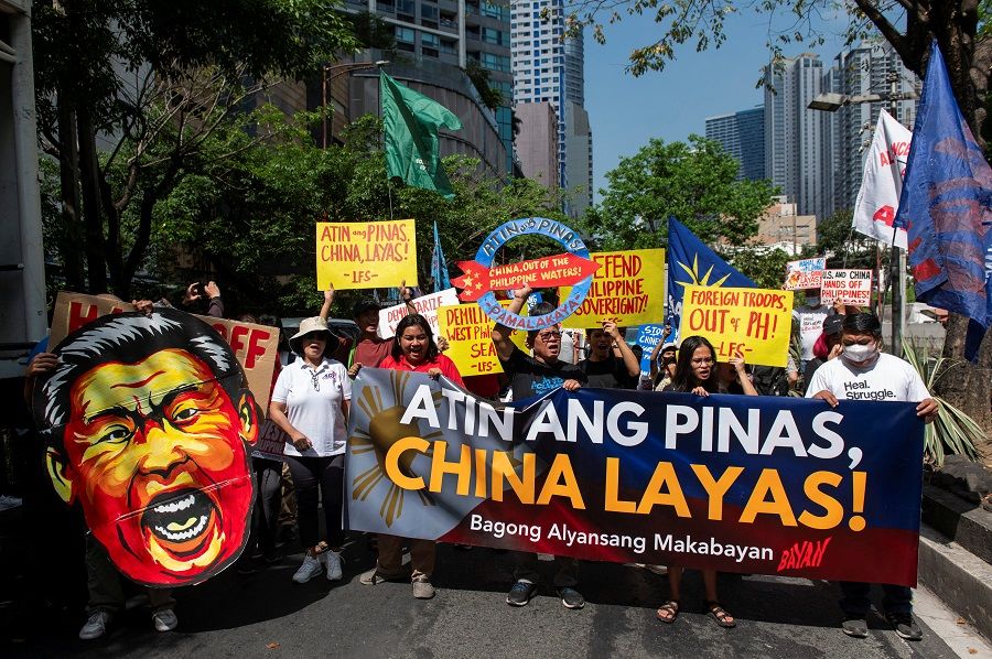 Filipino activists hold a protest condemning China’s actions during an encounter in the disputed waters of the South China Sea, outside of the Chinese Consulate in Makati City, Metro Manila, Philippines, on 9 April 2024.  (Lisa Marie David/Reuters)