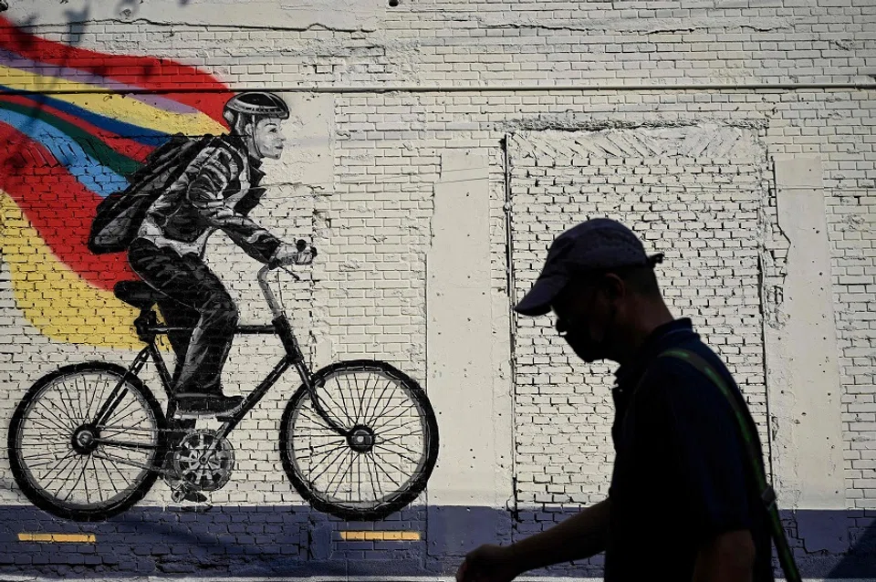 A man walks past a mural on a street in Beijing, China, on 28 September 2022. (Jade Gao/AFP)
