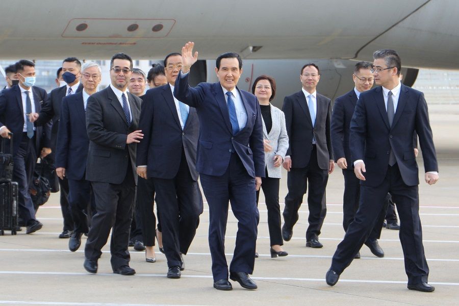 In this handout picture taken and released from former Taiwan President Ma Ying-jeou's office on 27 March 2023, former Taiwan President Ma Ying-jeou (centre) waves upon arriving at the Shanghai airport. (Handout/Ma Ying-jeou's office/AFP)