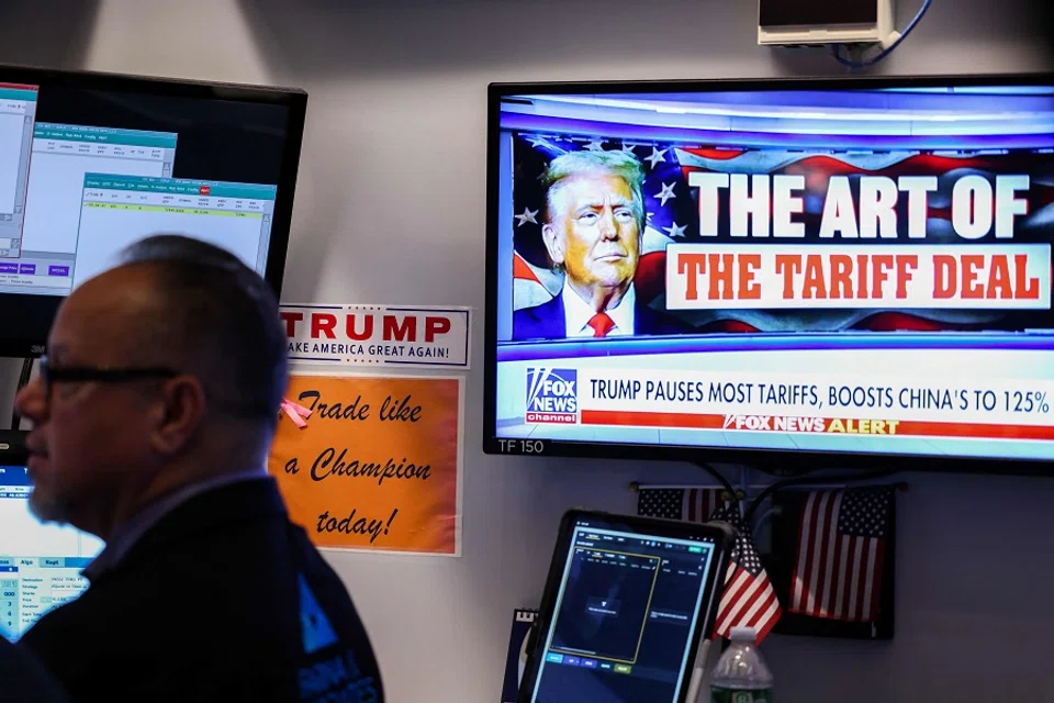 A trader works as a television screen shows news about US President Donald Trump’s trade and tariff policies, on the floor of the New York Stock Exchange (NYSE) at the opening bell on 10 April 2025, in New York City, US. (Charly Triballeau/AFP)