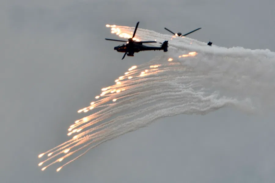 Two US-made AH-64E Apache attack helicopters release flares during the annual Han Kuang military drills in Taichung on 16 July 2020. (Sam Yeh/AFP)