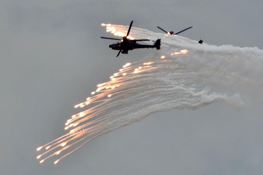 Two US-made AH-64E Apache attack helicopters release flares during the annual Han Kuang military drills in Taichung on 16 July 2020. (Sam Yeh/AFP)