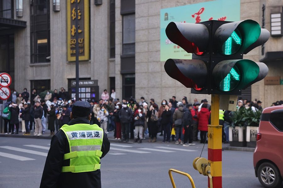 Temporary traffic lights and traffic police at Huanghe Road in Shanghai, China, to manage the crowd who have flocked to the area to take photographs following the airing of Blossoms Shanghai, on 11 January 2024. (CNS)