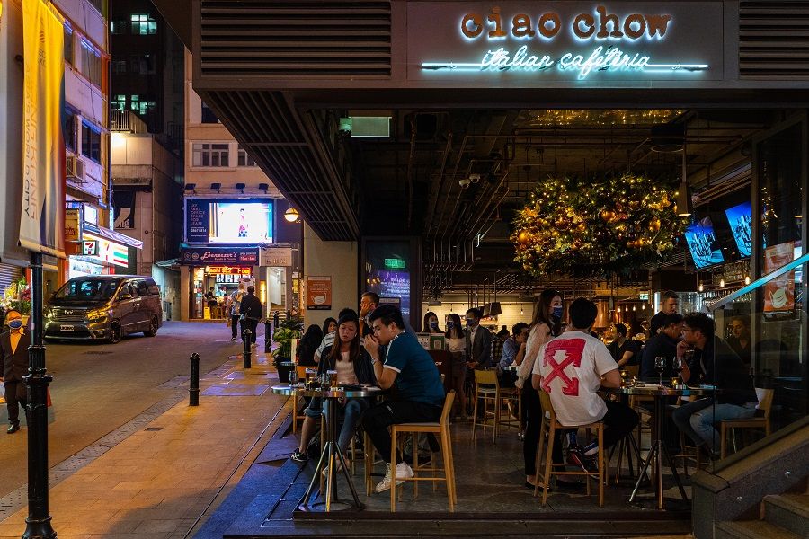 Visitors eat and drink in an open restaurant in the Lan Kwai Fong nightlife area in Hong Kong, China, on 27 November 2020. (Chan Long Hei/Bloomberg)