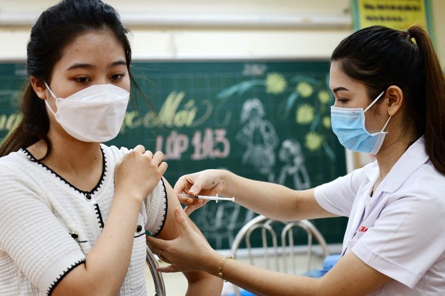 A woman (left) receives the Sinopharm Covid-19 coronavirus vaccine in Hanoi on 10 September 2021. (Nhac Nguyen/AFP)