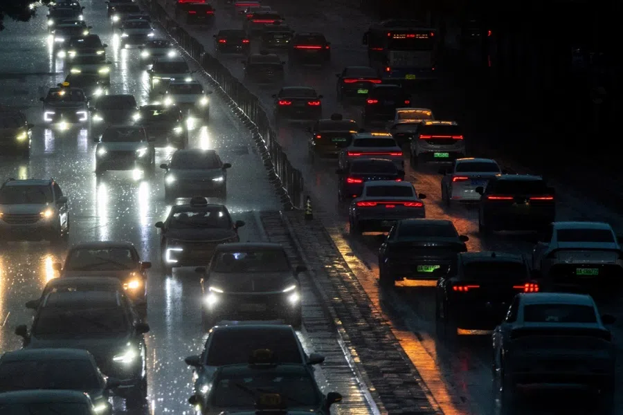 Cars drive along a street during heavy rain in Beijing, China, on 7 August 2026.