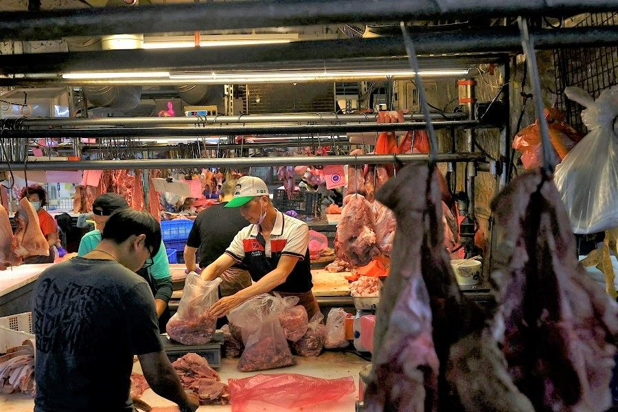 People buy and sell meat in Taipei, Taiwan, 17 January 2023. (Ann Wang/Reuters)